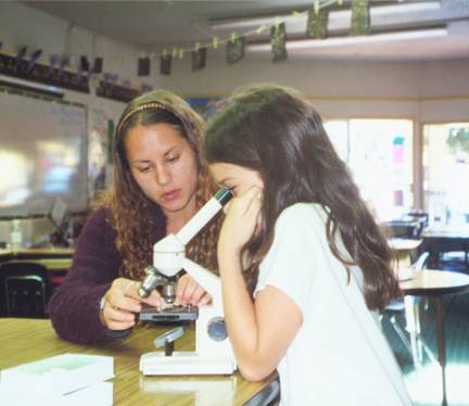 girl using microscope